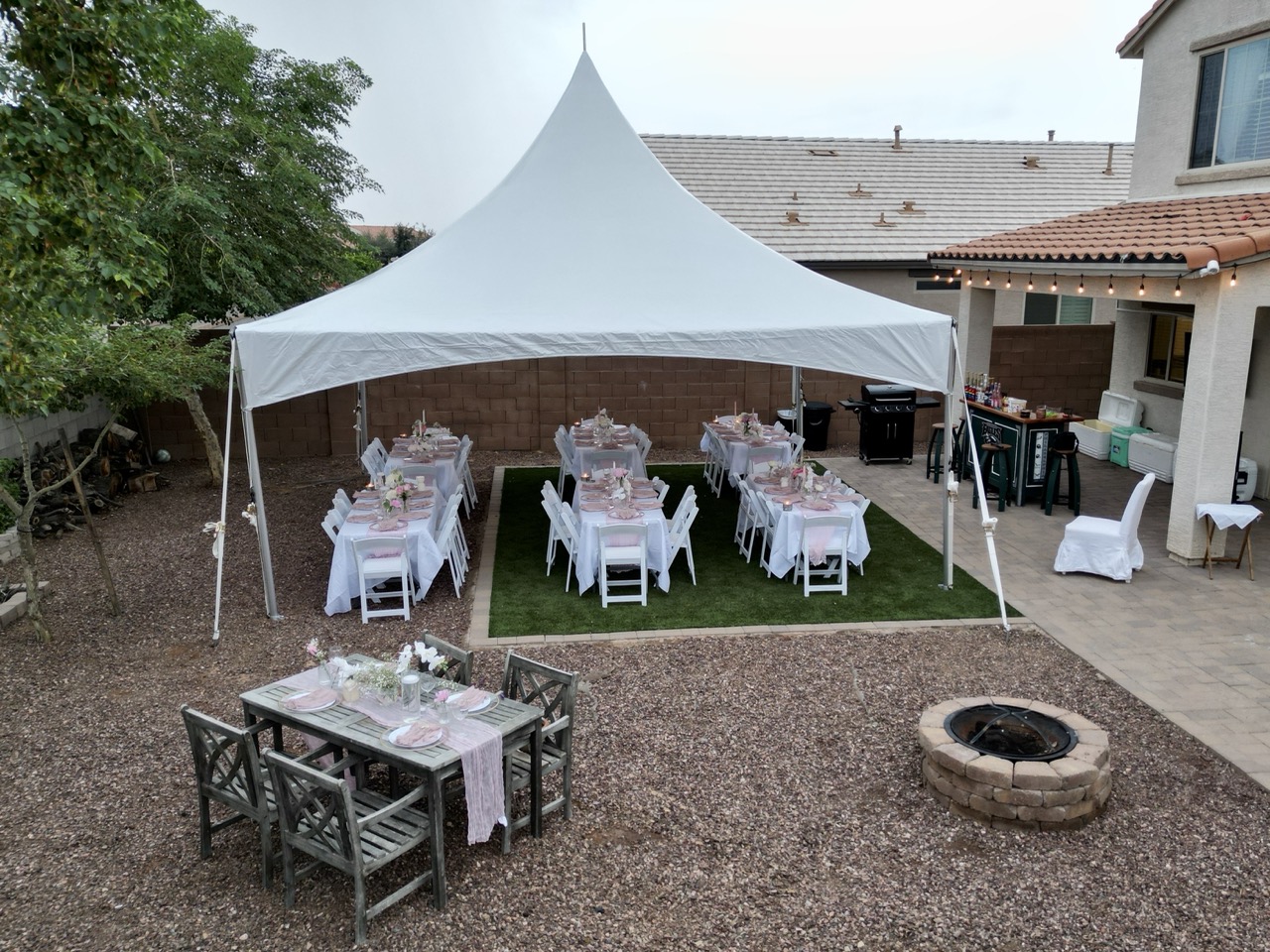 Elegant backyard tent setup with tables and formal dining arrangement in Brandon FL