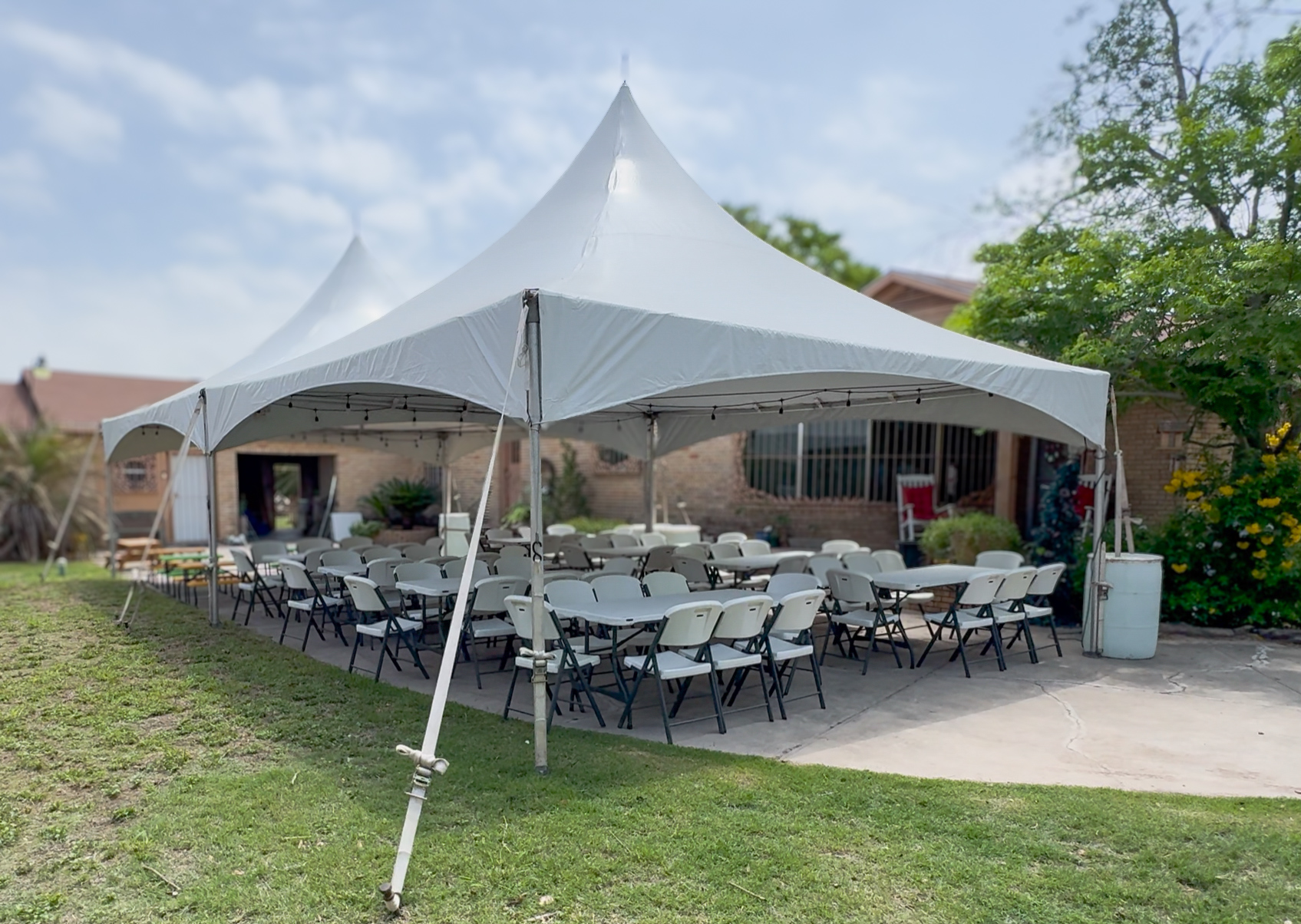 Large tent setup with rows of chairs for outdoor graduation event in Plant City